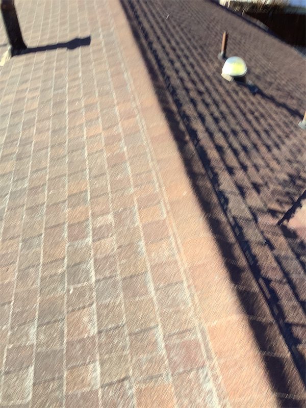 Before photo of hail damaged roof at residential property in Laramie Wyoming. Pete's Builders Commercial and Residential Roofing inspected this Laramie home for storm and hail damage prior to roof replacement. Serving Laramie WY, Cheyenne WY, and SE Wyoming. Free roof inspections available. Call (307) 514-5489.